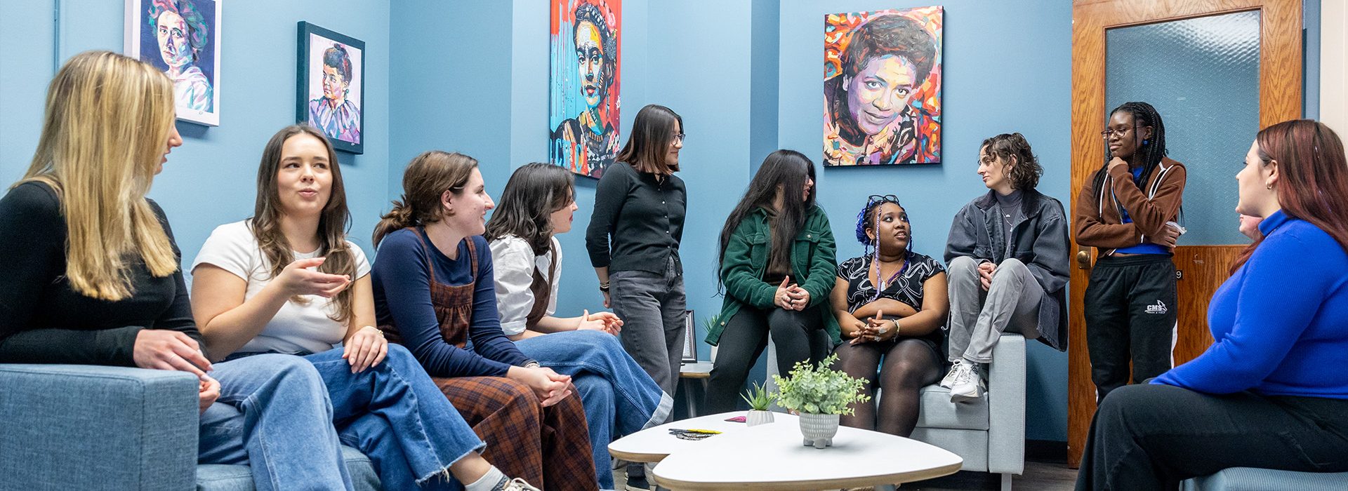 Students at a gathering for women's, gender, and sexuality studies majors.