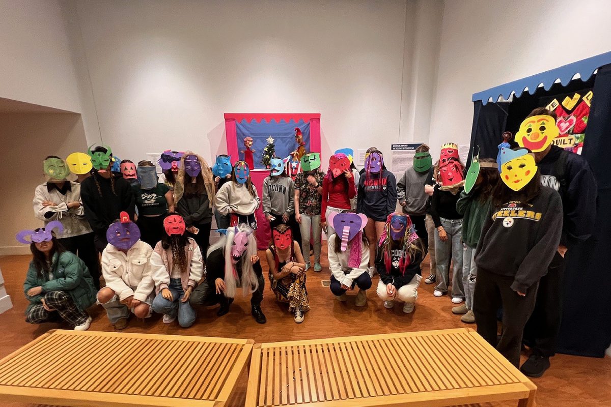 Students from WGSS 1105 pose with masks at the Ballard Institute and Museum of Puppetry. 